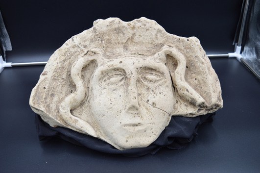Acroterio, maschera in terracotta utilizzata per decorare la sommità del tetto, all'altezza della trave principale. Sulla fronte è presente un incavo 
